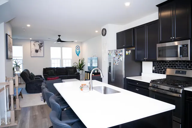 a living room with furniture a mirror and a table