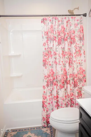 a large bed sitting in a bedroom next to a window