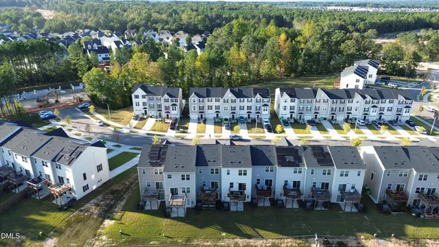 a aerial view of a house with swimming pool and large trees