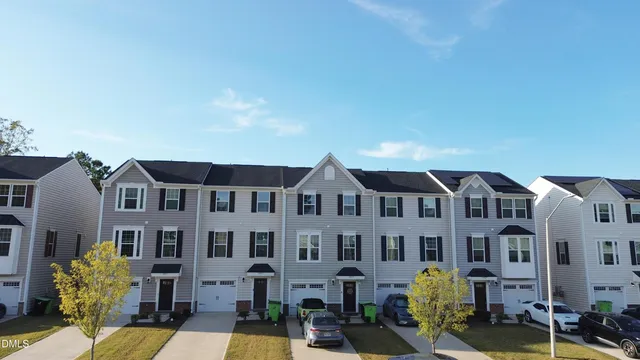 a front view of a building with glass windows and brick walls