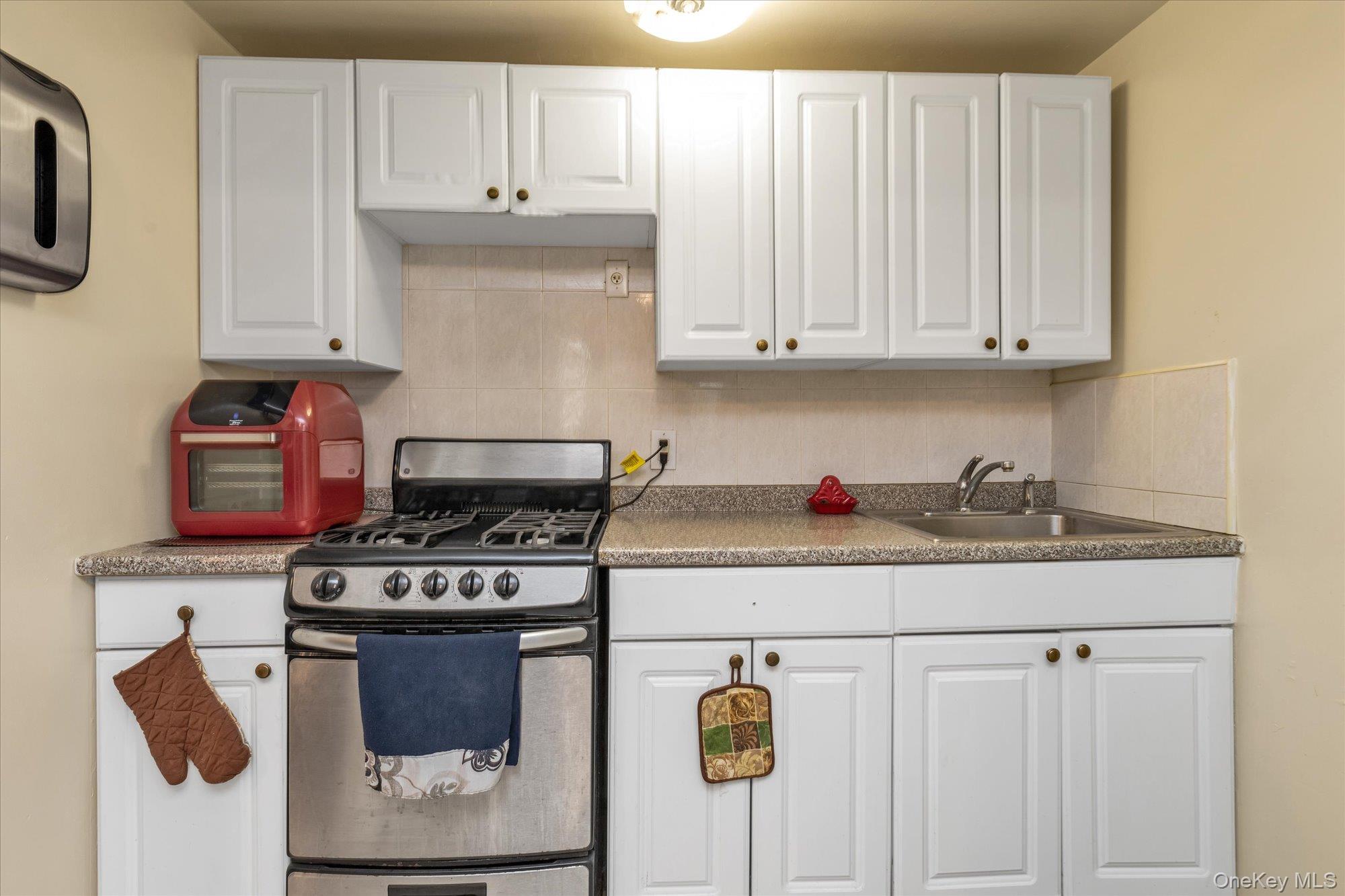 2301 Camp Road Queens, NY 11691 - Photo 16 of 23 a kitchen with a stove and cabinets