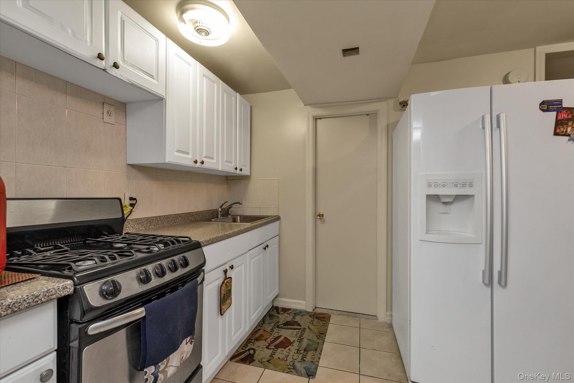 2301 Camp Road Queens, NY 11691 - Photo 17 of 23 a kitchen with a stove and a refrigerator