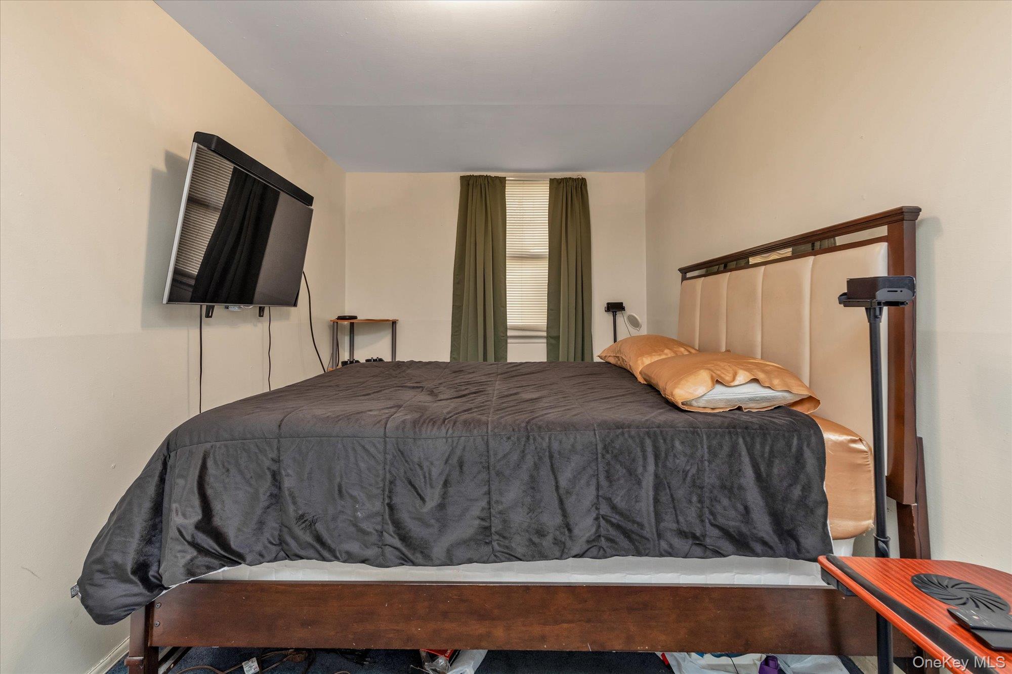 2301 Camp Road Queens, NY 11691 - Photo 19 of 23 a bedroom with a bed and a flat screen tv