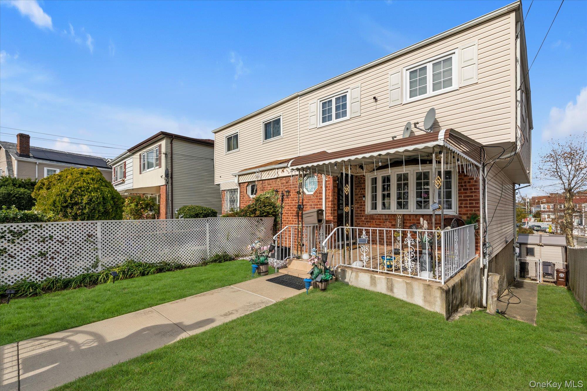 2301 Camp Road Queens, NY 11691 - Photo 2 of 23 a view of a house with a yard and deck