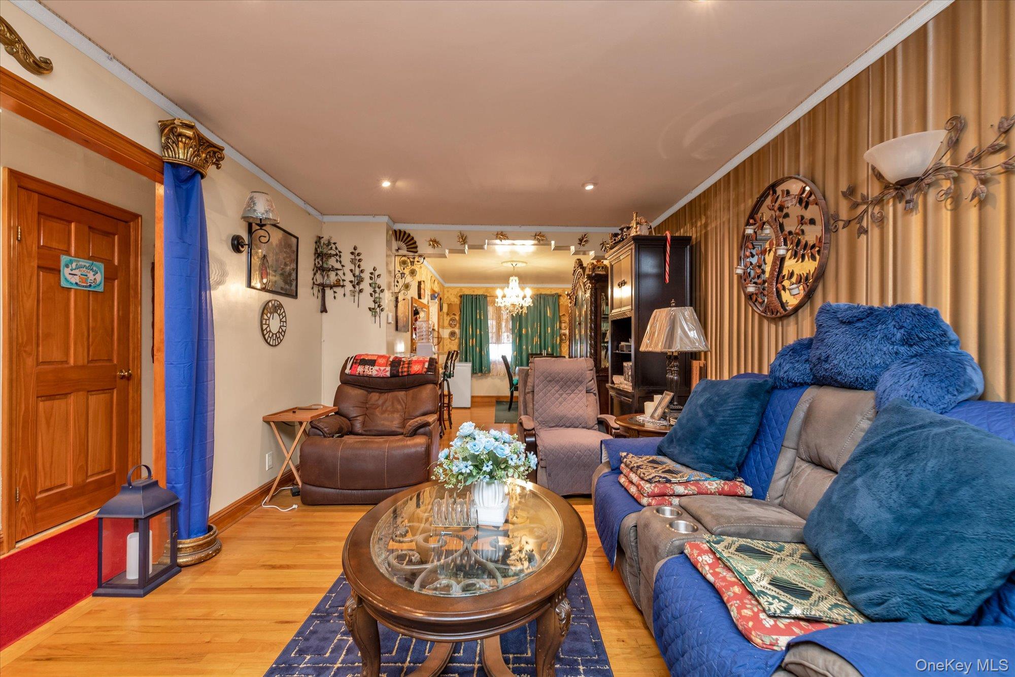2301 Camp Road Queens, NY 11691 - Photo 3 of 23 a living room with furniture and a chandelier