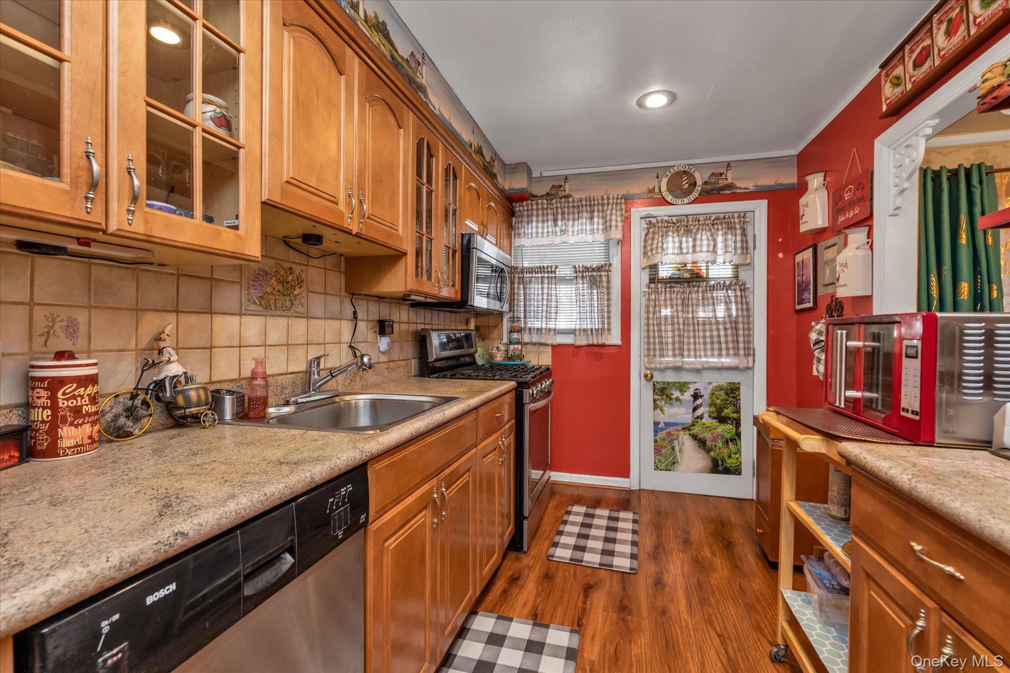 2301 Camp Road Queens, NY 11691 - Photo 8 of 23 a kitchen with stainless steel appliances granite countertop a sink stove and cabinets