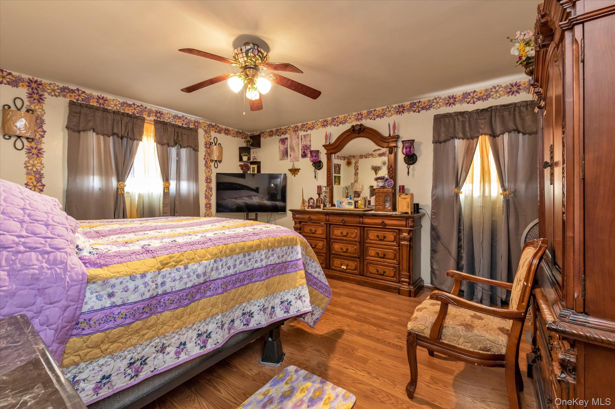 2301 Camp Road Queens, NY 11691 - Photo 9 of 23 a bedroom with a bed and dresser with wooden floor