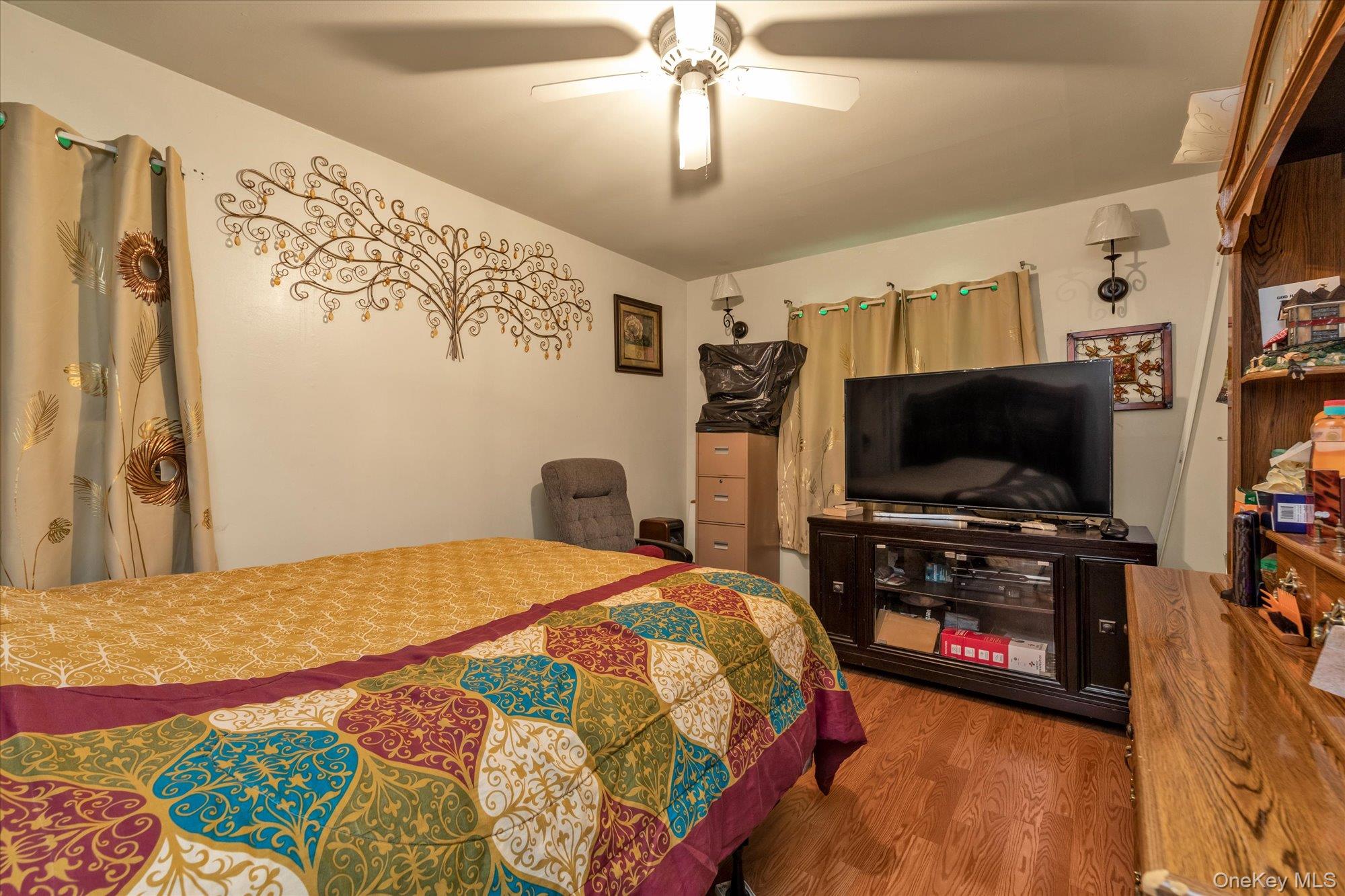 2301 Camp Road Queens, NY 11691 - Photo 10 of 23 a bedroom with a bed and a flat screen tv