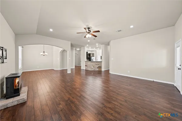 wooden floor in an empty room with a kitchen