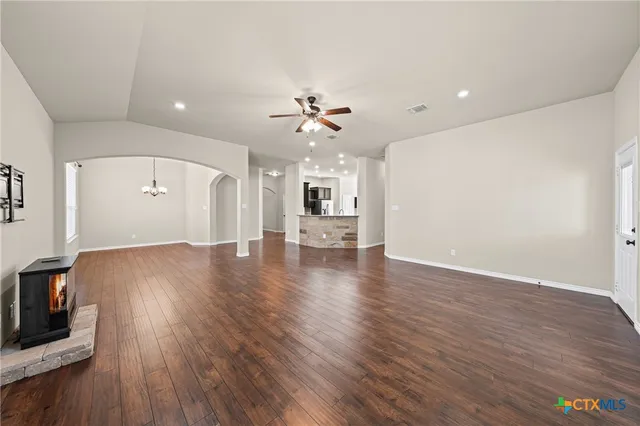 a view of a room with wooden floor and window