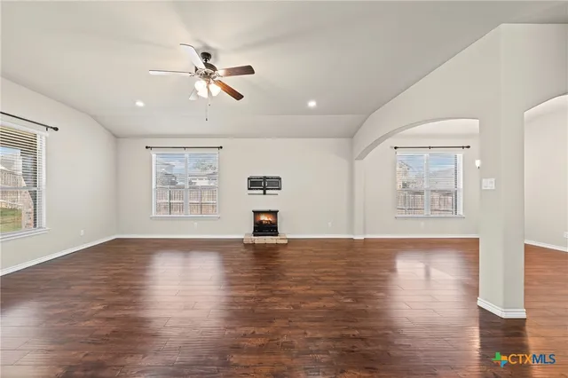 a kitchen with stainless steel appliances granite countertop a refrigerator a sink dishwasher a stove with wooden floors