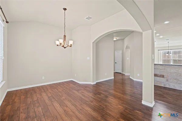 a view of a room with wooden floor and window