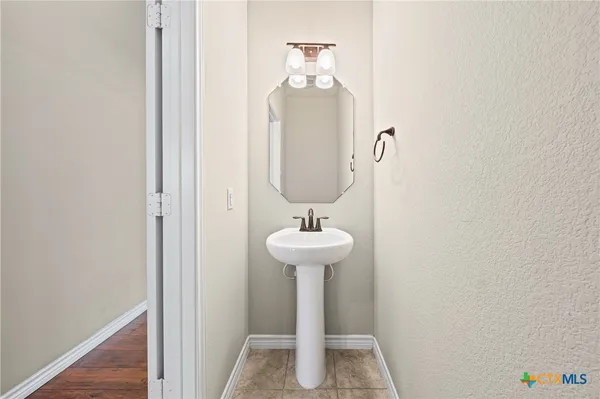 a bathroom with a sink a mirror and toilet