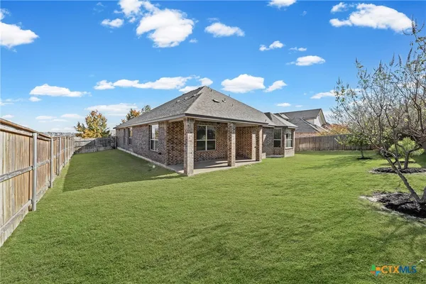 a view of a house with a backyard