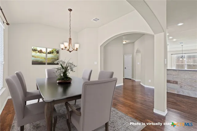 a view of a dining room with furniture and wooden floor