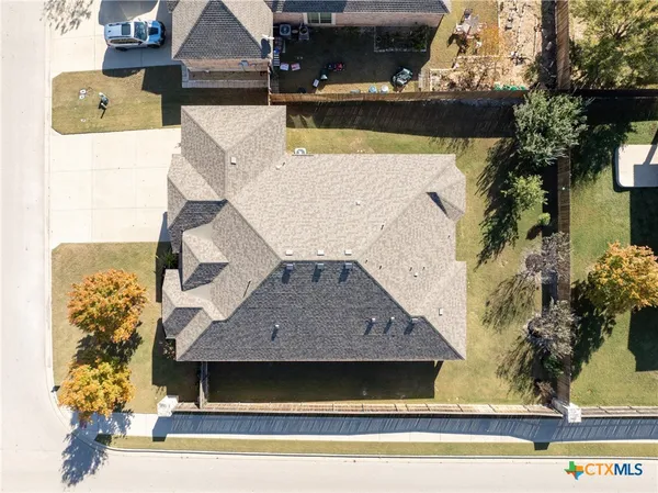 an aerial view of a house with a yard