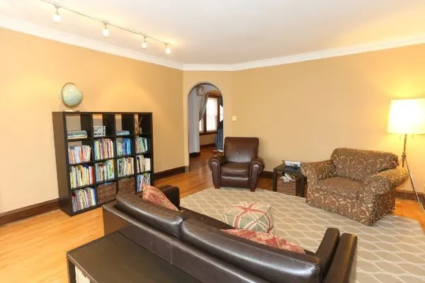 a living room with furniture and a wooden floor