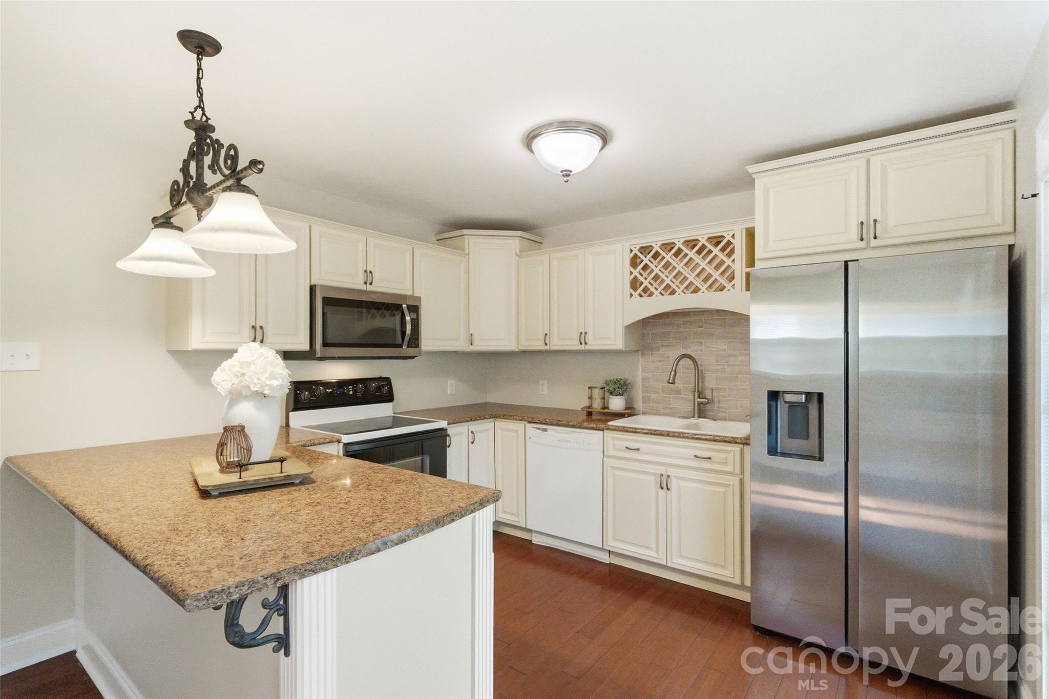 2291 Hicklin Bridge Road Edgemoor, SC 29712 - Photo 18 of 42 a kitchen with stainless steel appliances granite countertop a sink refrigerator and microwave