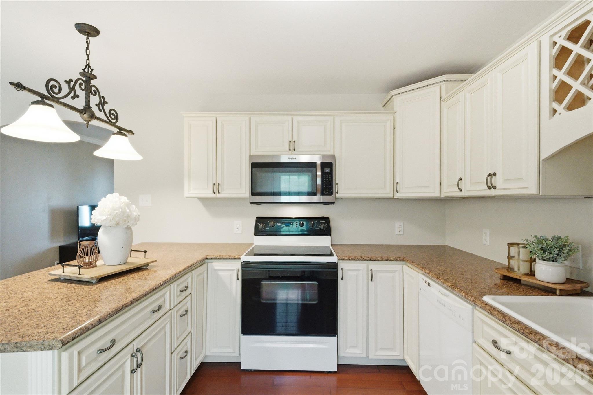 2291 Hicklin Bridge Road Edgemoor, SC 29712 - Photo 19 of 42 a kitchen with kitchen island granite countertop white cabinets and stainless steel appliances