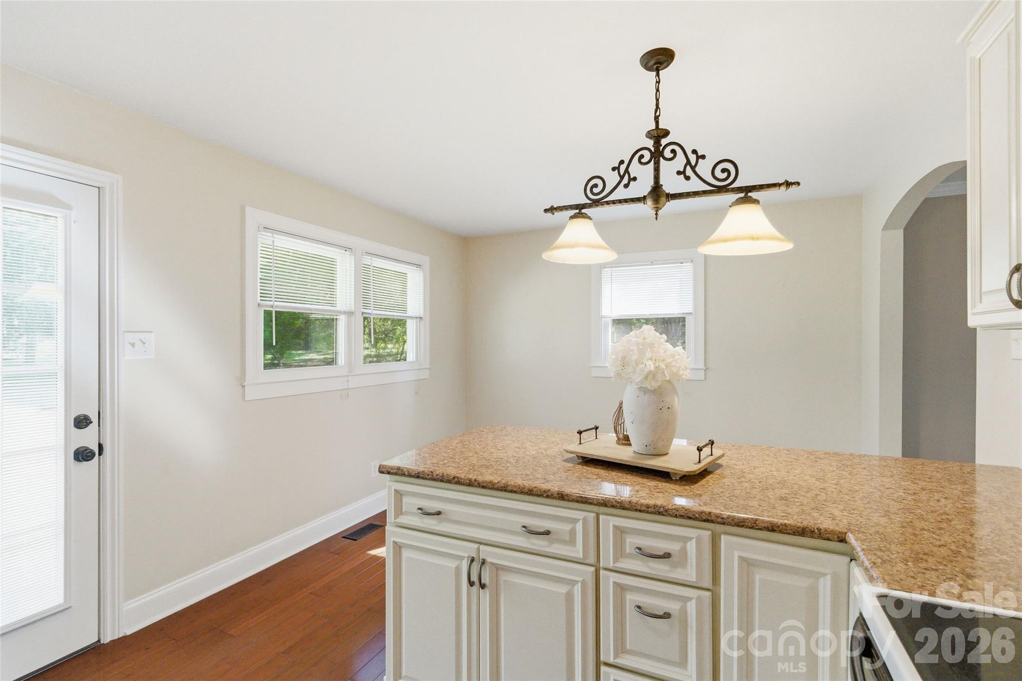 2291 Hicklin Bridge Road Edgemoor, SC 29712 - Photo 20 of 42 a kitchen with a sink a chandelier and wooden floor