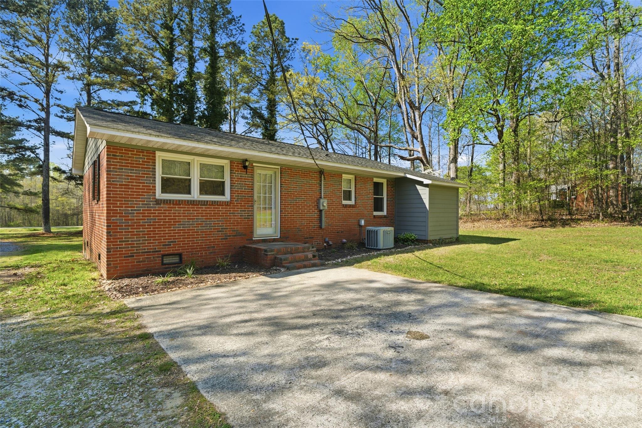 2291 Hicklin Bridge Road Edgemoor, SC 29712 - Photo 24 of 42 a backyard of a house with large trees and a big yard