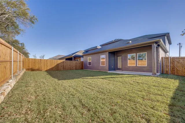 a view of backyard with large tree