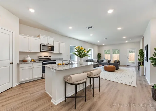 a kitchen with white cabinets and stainless steel appliances