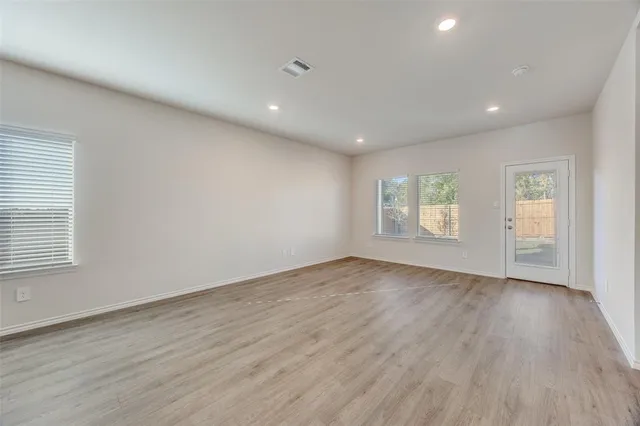 a open kitchen with stainless steel appliances granite countertop sink stove and wooden floor