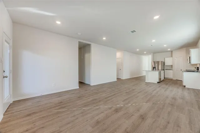 a view of kitchen with refrigerator and window