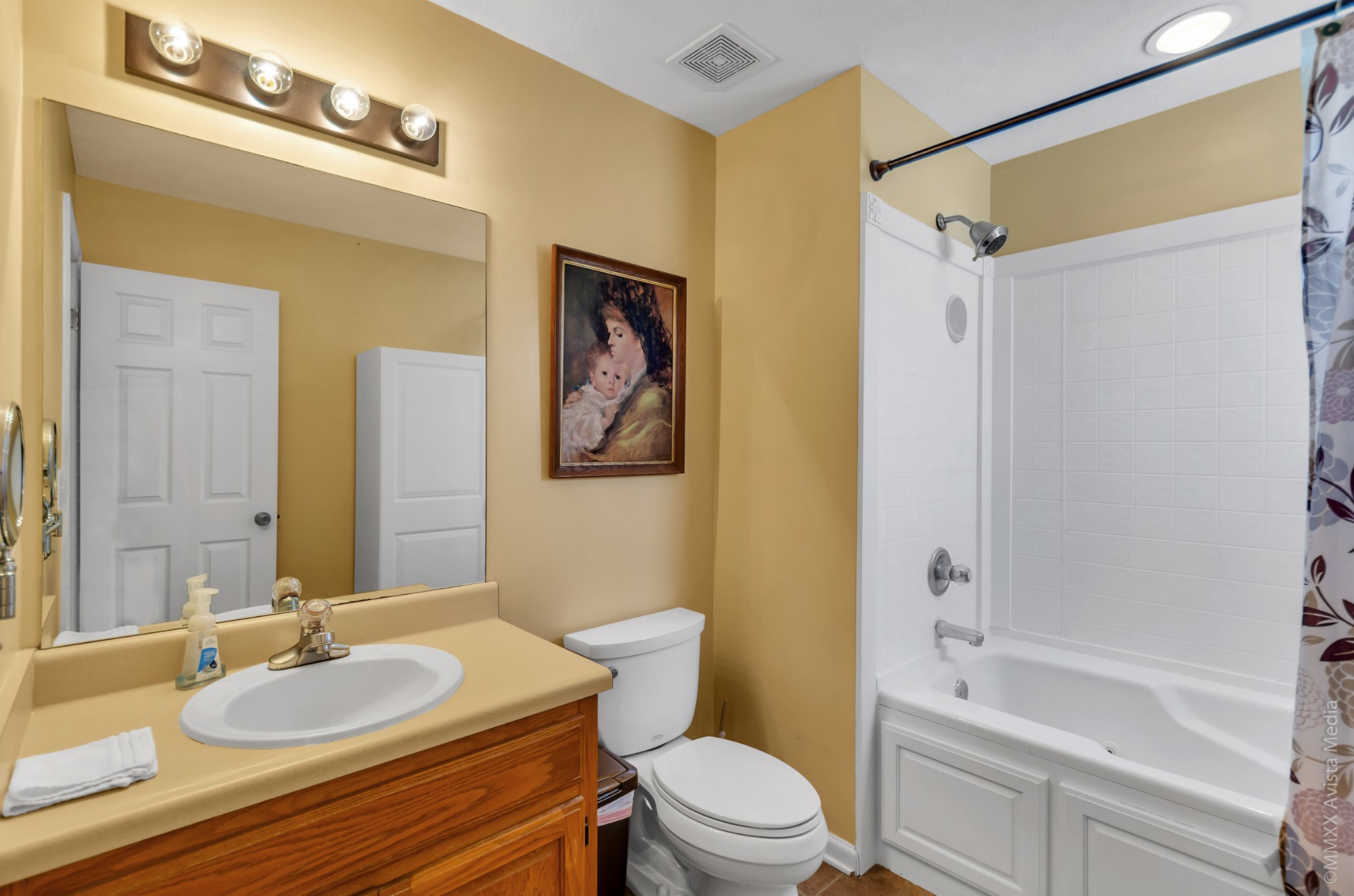 267 Ernest Cates Road Bethpage, TN 37022 - Photo 16 of 30 a bathroom with a granite countertop sink toilet a mirror a bathtub and shower