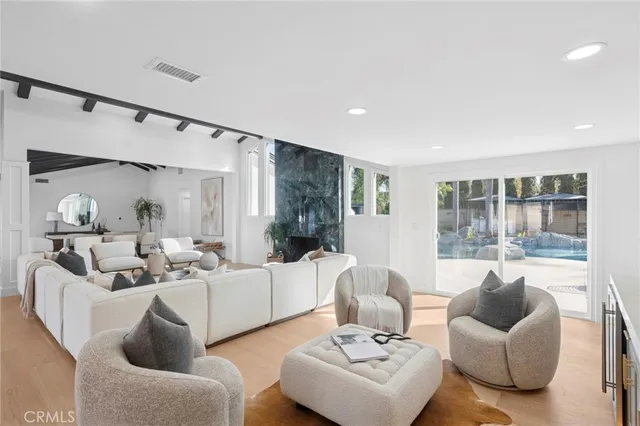 a spacious bathroom with a granite countertop sink a mirror and a shower