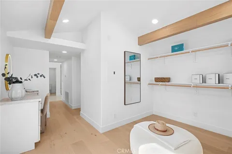 a view of a livingroom with furniture and a mirror