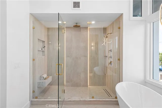 a spacious bedroom with a bed and a large window