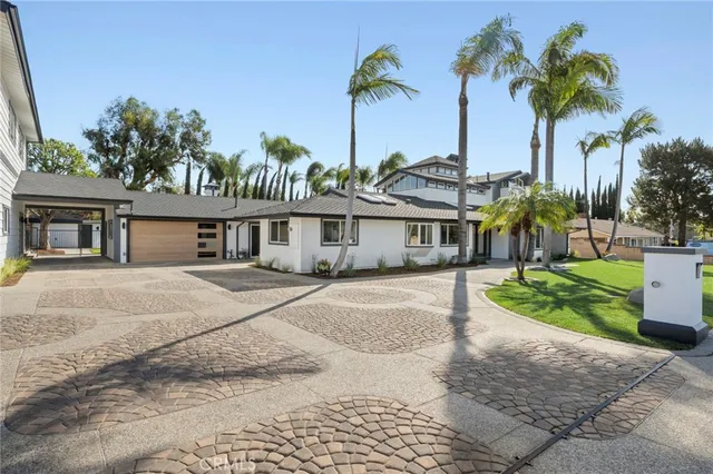 a kitchen with kitchen island a counter top space a sink stainless steel appliances and cabinets