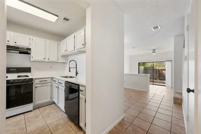 a kitchen with stainless steel appliances granite countertop a stove and a sink
