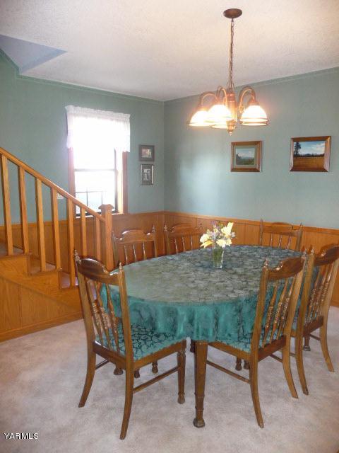 421 Blaine Road Granger, WA 98932 - Photo 6 of 23 a dining room with furniture a chandelier and window