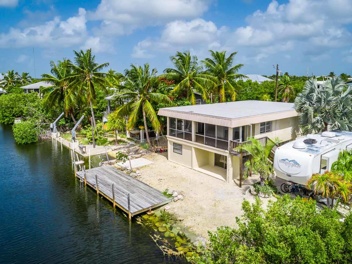 27346 Martinique Lane Summerland Key, FL 33042 - Photo 1 of 33 a view of a house with pool and chairs