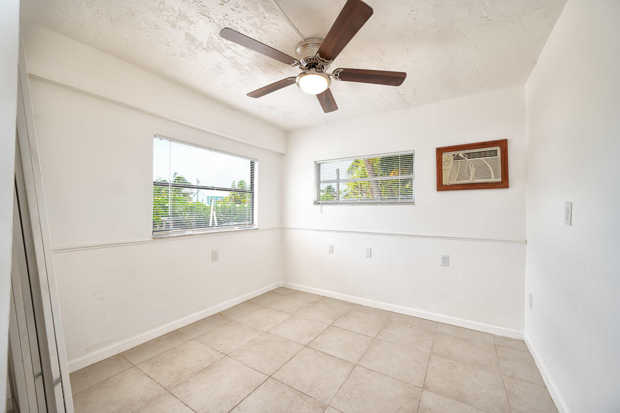 27346 Martinique Lane Summerland Key, FL 33042 - Photo 14 of 33 an empty room with a window and a ceiling fan