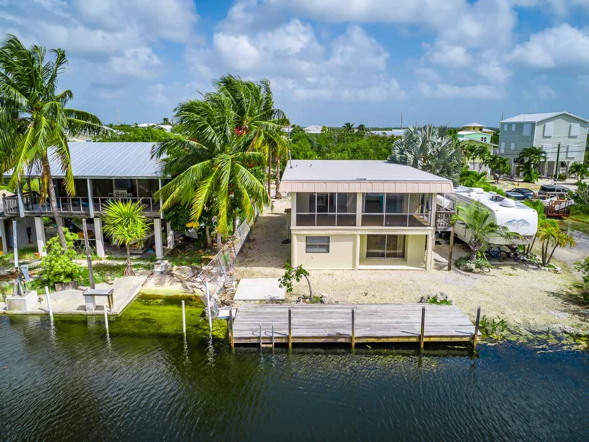 27346 Martinique Lane Summerland Key, FL 33042 - Photo 23 of 33 a view of house with yard outdoor seating and lake view
