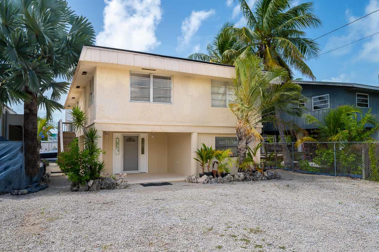 27346 Martinique Lane Summerland Key, FL 33042 - Photo 25 of 33 a backyard of a house with plants and trees