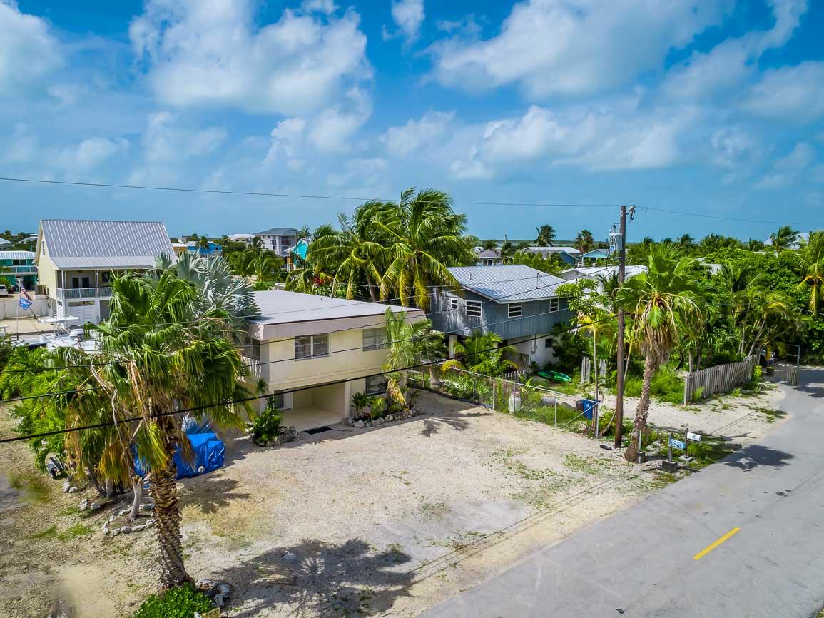 27346 Martinique Lane Summerland Key, FL 33042 - Photo 28 of 33 a view of a house with wooden fence next to a road