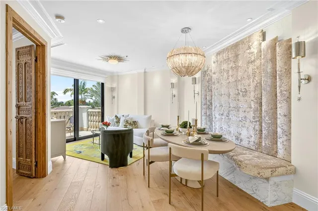 a dining room with furniture a chandelier and wooden floor