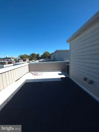 a view of balcony with furniture and a floor to ceiling window
