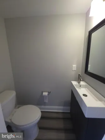 a bathroom with a toilet sink and mirror