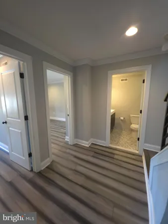 a view of a room with wooden floor and bathroom