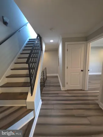 a view of entryway and hall with wooden floor