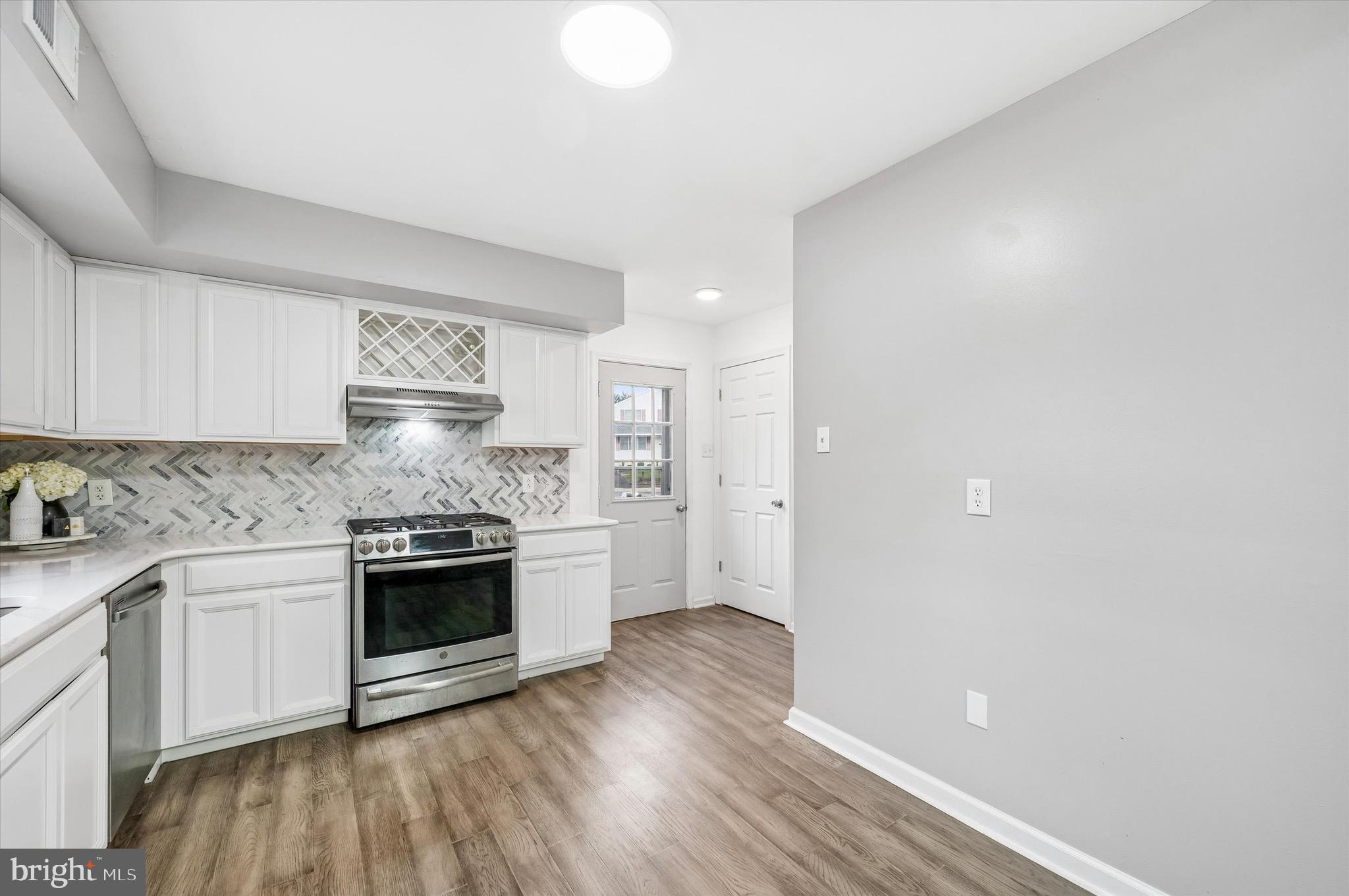 22 East Belair Road Ridley Park, PA 19078 - Photo 12 of 36 a kitchen with granite countertop a sink cabinets and stainless steel appliances