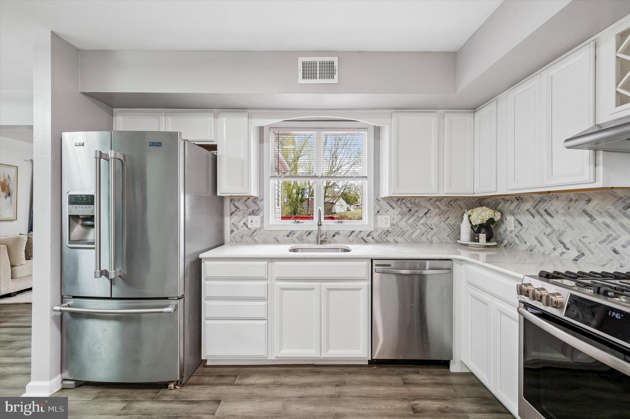 22 East Belair Road Ridley Park, PA 19078 - Photo 14 of 36 a kitchen with a stove a sink and a refrigerator