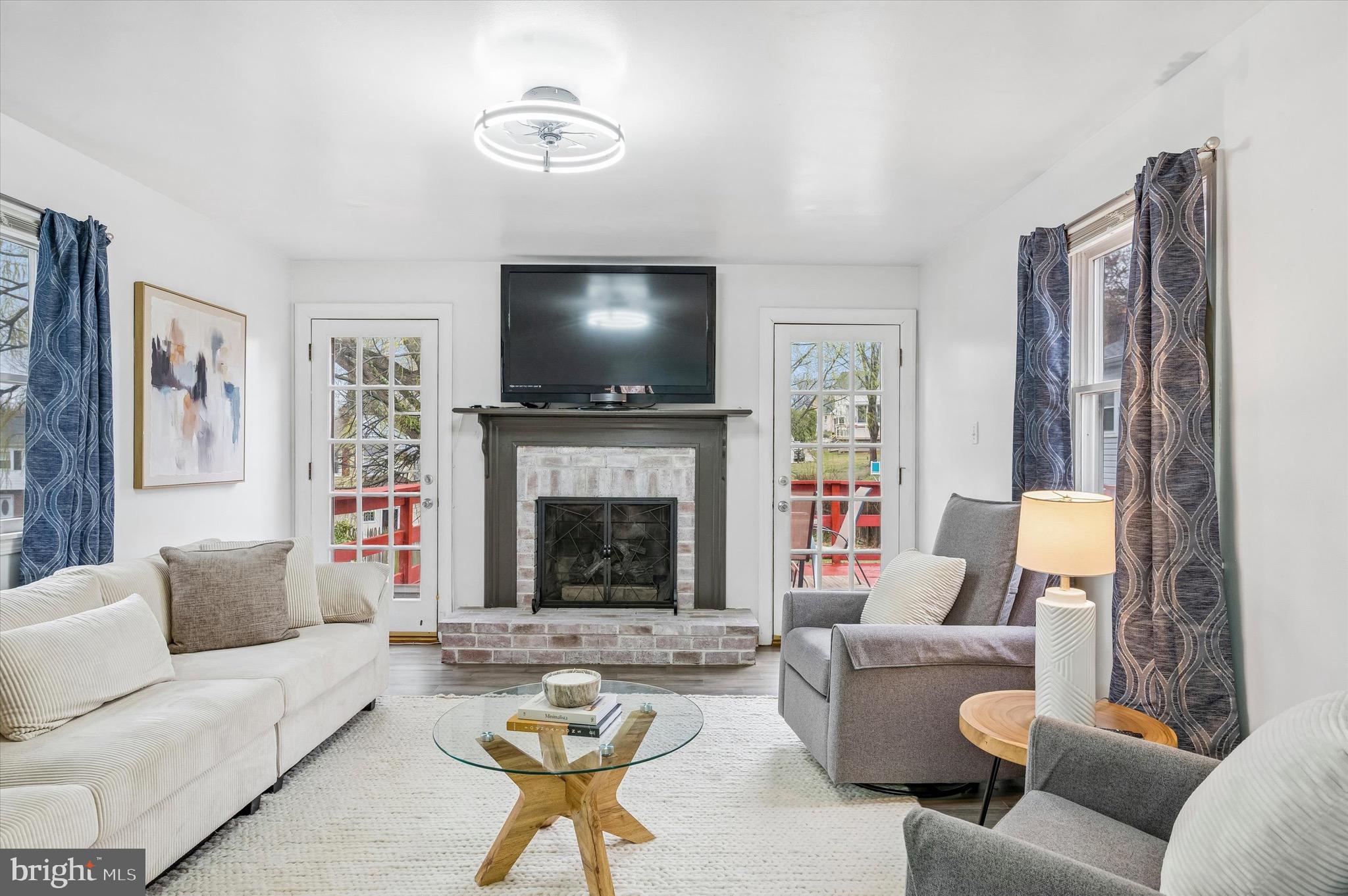 22 East Belair Road Ridley Park, PA 19078 - Photo 19 of 36 a living room with furniture a flat screen tv and a fireplace