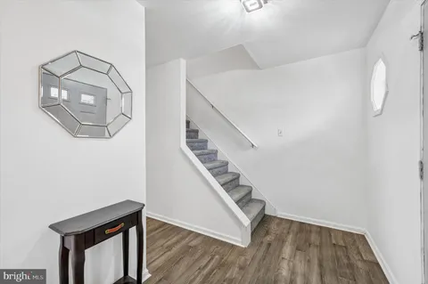 a view of entryway and hall with wooden floor